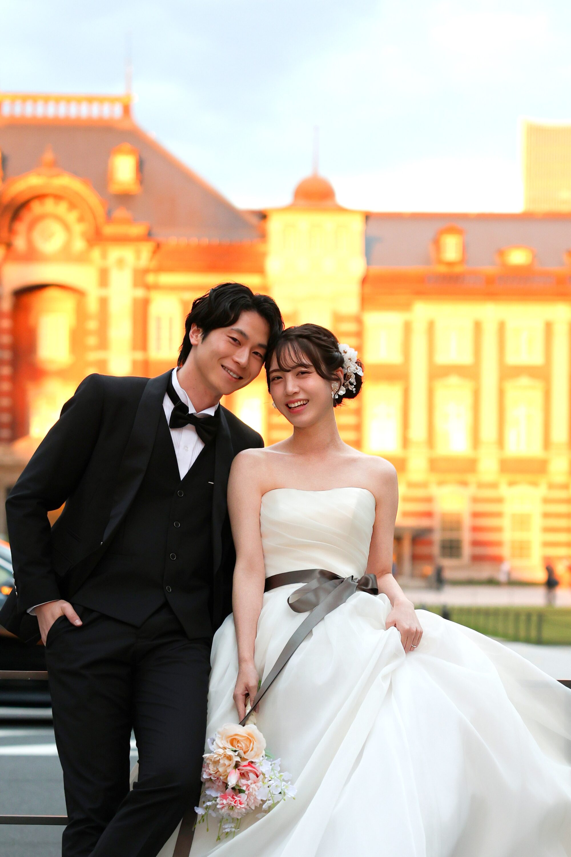東京駅でウェディングドレスとタキシードを着てフォトウェディングの撮影をする新郎様と新婦様の写真。撮影：STUDIOARC